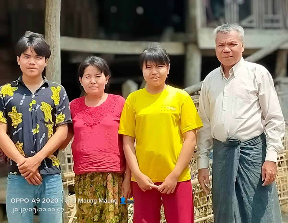 Pastor Maung and three members of his family standing together outside in Myanmar.