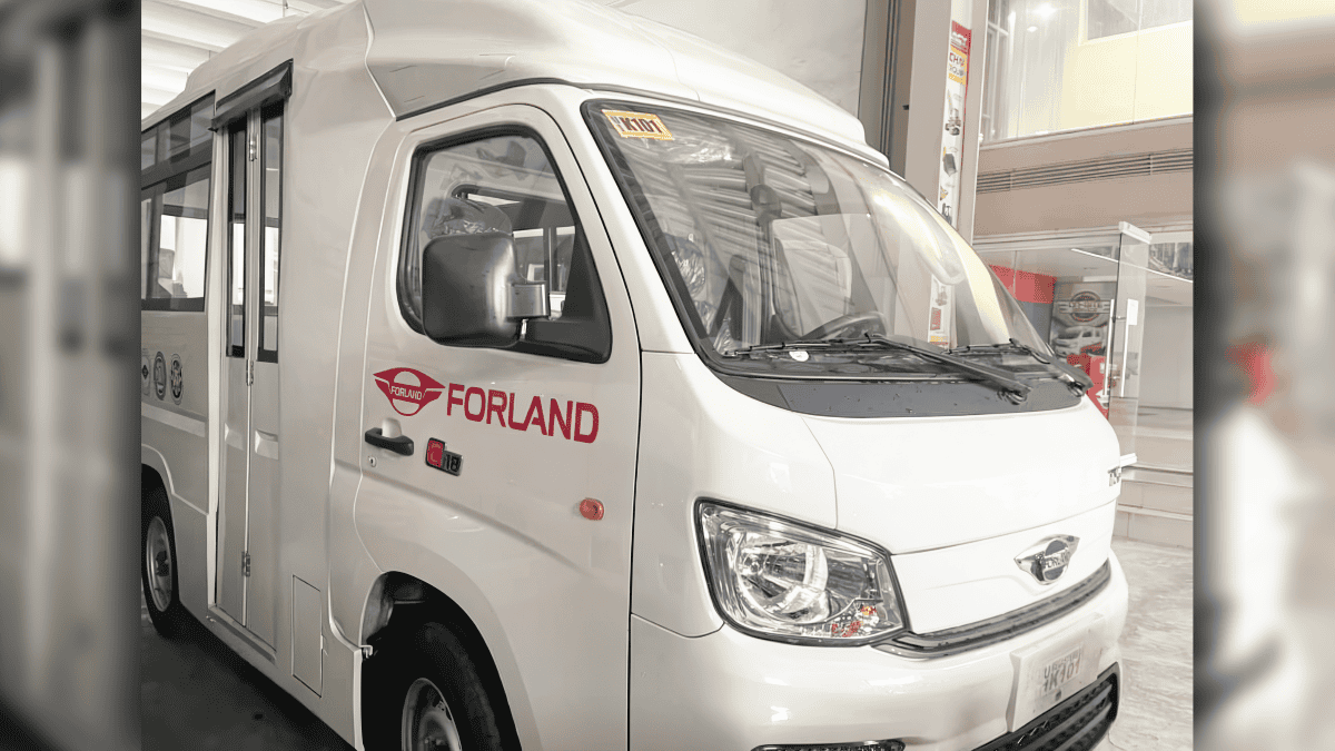 A white Forland medical mission vehicle designed for outreach services, parked indoors. The vehicle features an 18-foot body with "Forland" branding on the side, equipped to carry medical supplies and a dedicated team to remote areas.